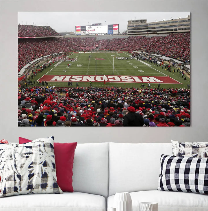 A living room exhibits the premium Wisconsin Badgers Football Team Print - Madison Camp Randall Stadium Wall Art Canvas Print, a triptych displaying an exciting game at Wisconsin. This canvas artwork infuses the space with vibrant energy.