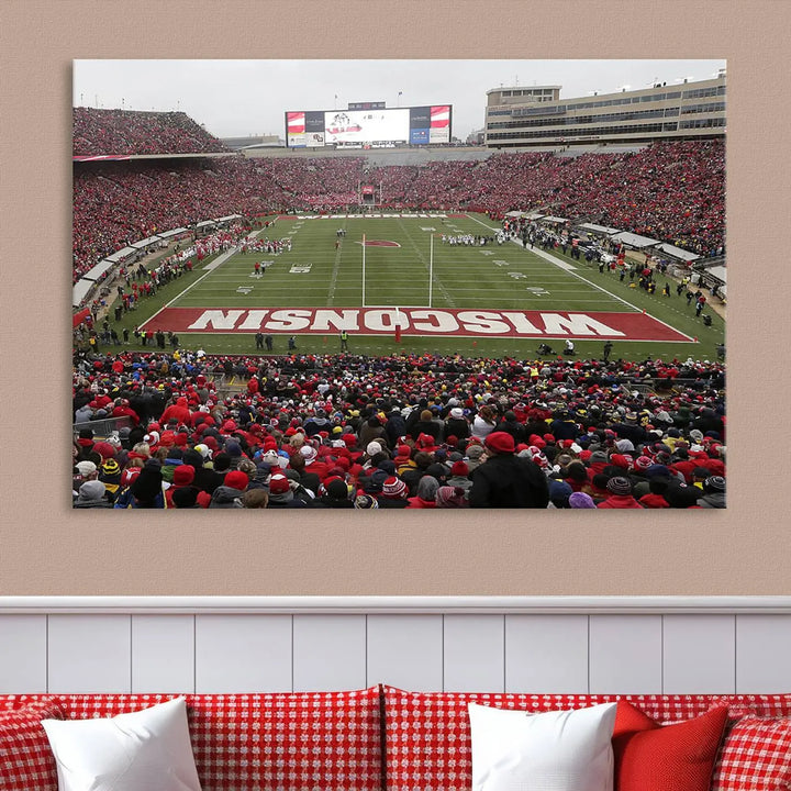 A living room exhibits the premium Wisconsin Badgers Football Team Print - Madison Camp Randall Stadium Wall Art Canvas Print, a triptych displaying an exciting game at Wisconsin. This canvas artwork infuses the space with vibrant energy.