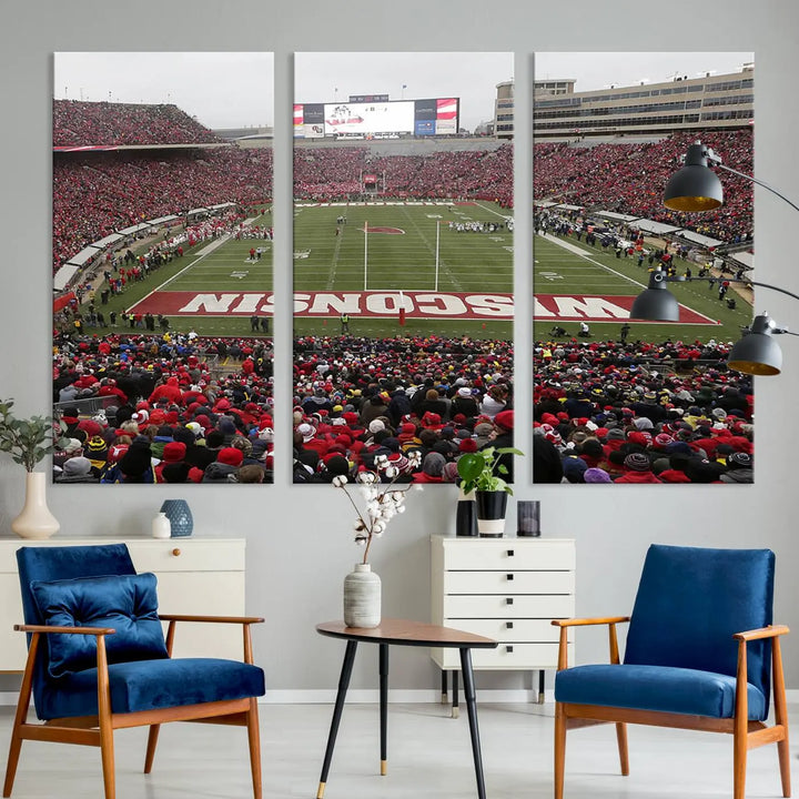 A living room exhibits the premium Wisconsin Badgers Football Team Print - Madison Camp Randall Stadium Wall Art Canvas Print, a triptych displaying an exciting game at Wisconsin. This canvas artwork infuses the space with vibrant energy.