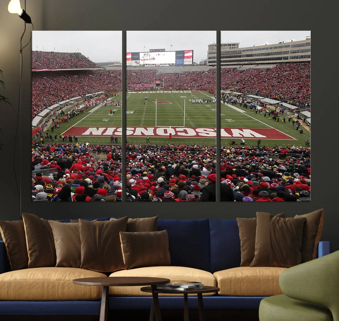 A living room exhibits the premium Wisconsin Badgers Football Team Print - Madison Camp Randall Stadium Wall Art Canvas Print, a triptych displaying an exciting game at Wisconsin. This canvas artwork infuses the space with vibrant energy.