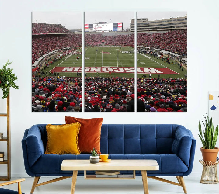 A living room exhibits the premium Wisconsin Badgers Football Team Print - Madison Camp Randall Stadium Wall Art Canvas Print, a triptych displaying an exciting game at Wisconsin. This canvas artwork infuses the space with vibrant energy.