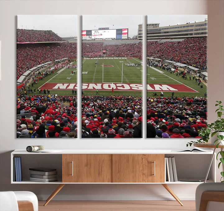 A living room exhibits the premium Wisconsin Badgers Football Team Print - Madison Camp Randall Stadium Wall Art Canvas Print, a triptych displaying an exciting game at Wisconsin. This canvas artwork infuses the space with vibrant energy.