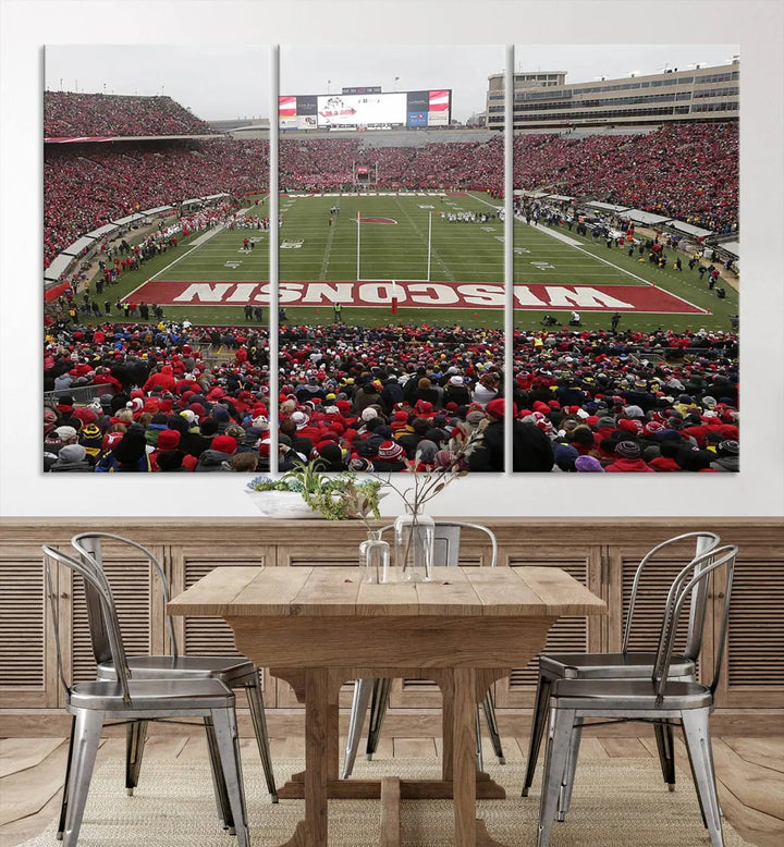 A living room exhibits the premium Wisconsin Badgers Football Team Print - Madison Camp Randall Stadium Wall Art Canvas Print, a triptych displaying an exciting game at Wisconsin. This canvas artwork infuses the space with vibrant energy.