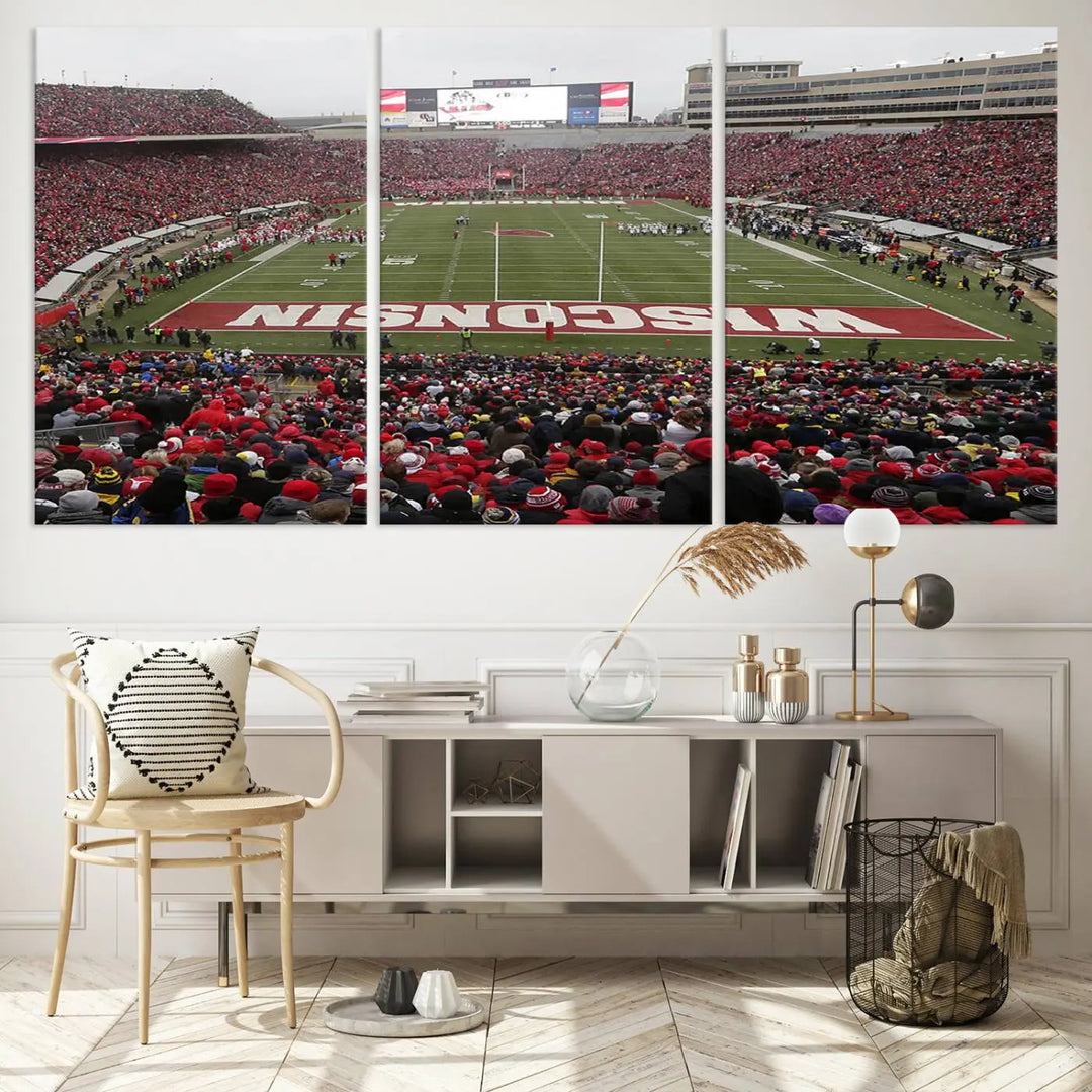 A living room exhibits the premium Wisconsin Badgers Football Team Print - Madison Camp Randall Stadium Wall Art Canvas Print, a triptych displaying an exciting game at Wisconsin. This canvas artwork infuses the space with vibrant energy.