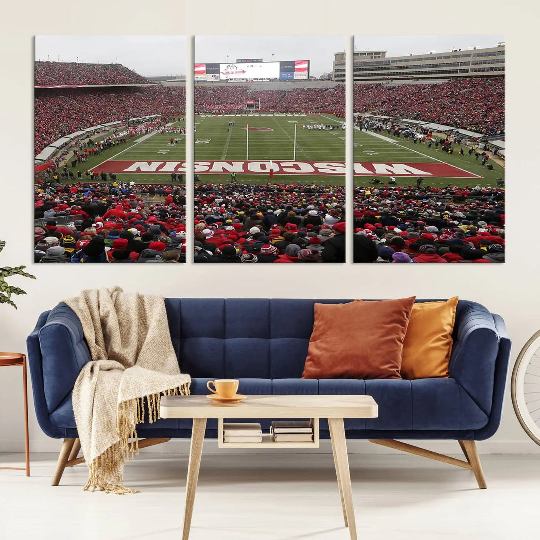 A living room exhibits the premium Wisconsin Badgers Football Team Print - Madison Camp Randall Stadium Wall Art Canvas Print, a triptych displaying an exciting game at Wisconsin. This canvas artwork infuses the space with vibrant energy.