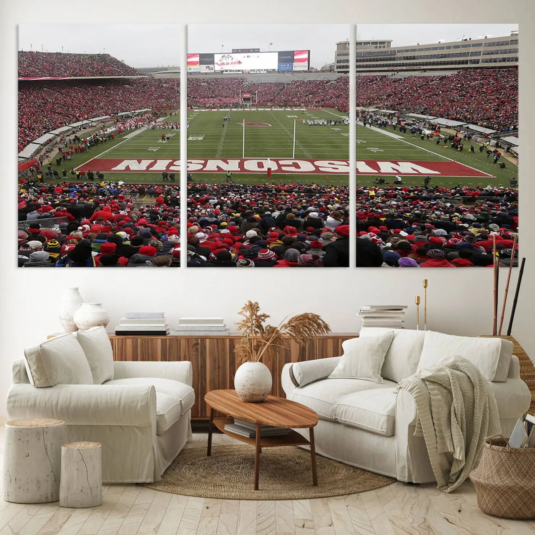 A living room exhibits the premium Wisconsin Badgers Football Team Print - Madison Camp Randall Stadium Wall Art Canvas Print, a triptych displaying an exciting game at Wisconsin. This canvas artwork infuses the space with vibrant energy.