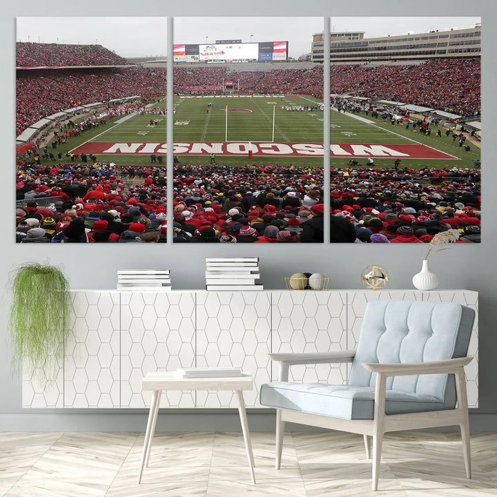 A living room exhibits the premium Wisconsin Badgers Football Team Print - Madison Camp Randall Stadium Wall Art Canvas Print, a triptych displaying an exciting game at Wisconsin. This canvas artwork infuses the space with vibrant energy.