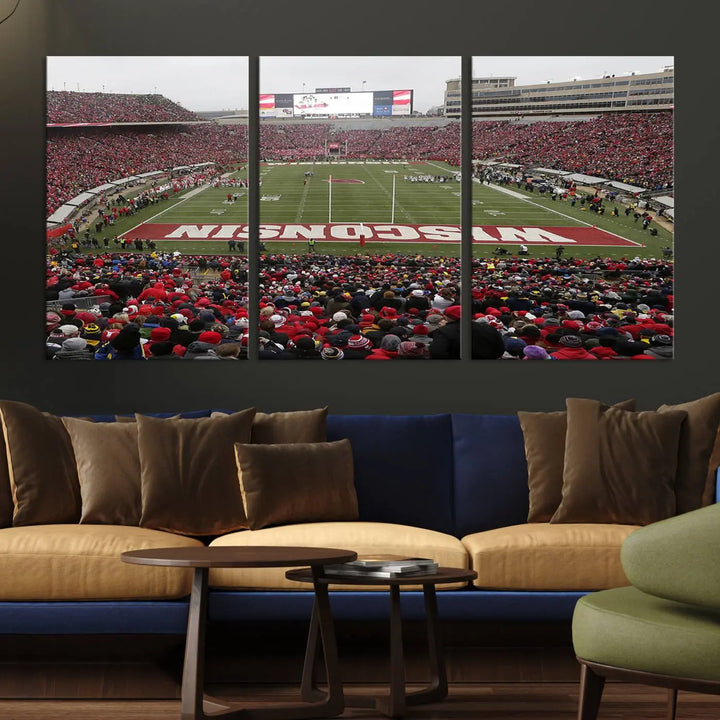 A living room exhibits the premium Wisconsin Badgers Football Team Print - Madison Camp Randall Stadium Wall Art Canvas Print, a triptych displaying an exciting game at Wisconsin. This canvas artwork infuses the space with vibrant energy.