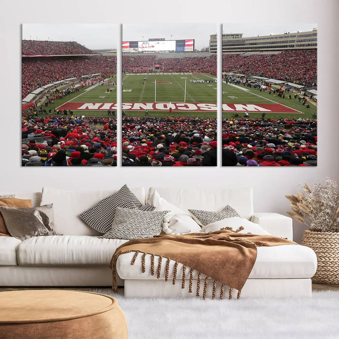 A living room exhibits the premium Wisconsin Badgers Football Team Print - Madison Camp Randall Stadium Wall Art Canvas Print, a triptych displaying an exciting game at Wisconsin. This canvas artwork infuses the space with vibrant energy.