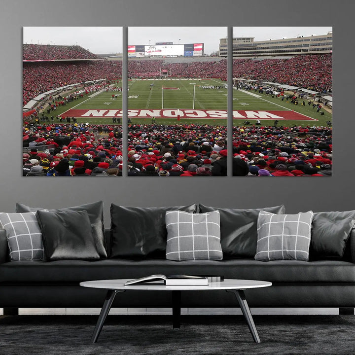 A living room exhibits the premium Wisconsin Badgers Football Team Print - Madison Camp Randall Stadium Wall Art Canvas Print, a triptych displaying an exciting game at Wisconsin. This canvas artwork infuses the space with vibrant energy.