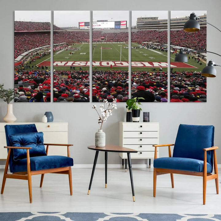 A living room exhibits the premium Wisconsin Badgers Football Team Print - Madison Camp Randall Stadium Wall Art Canvas Print, a triptych displaying an exciting game at Wisconsin. This canvas artwork infuses the space with vibrant energy.