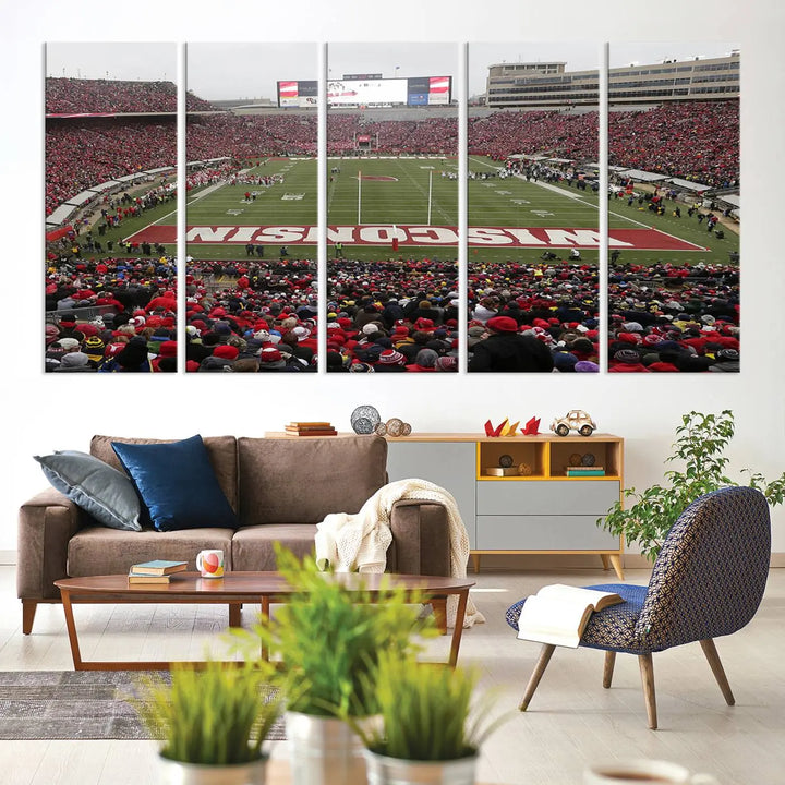 A living room exhibits the premium Wisconsin Badgers Football Team Print - Madison Camp Randall Stadium Wall Art Canvas Print, a triptych displaying an exciting game at Wisconsin. This canvas artwork infuses the space with vibrant energy.