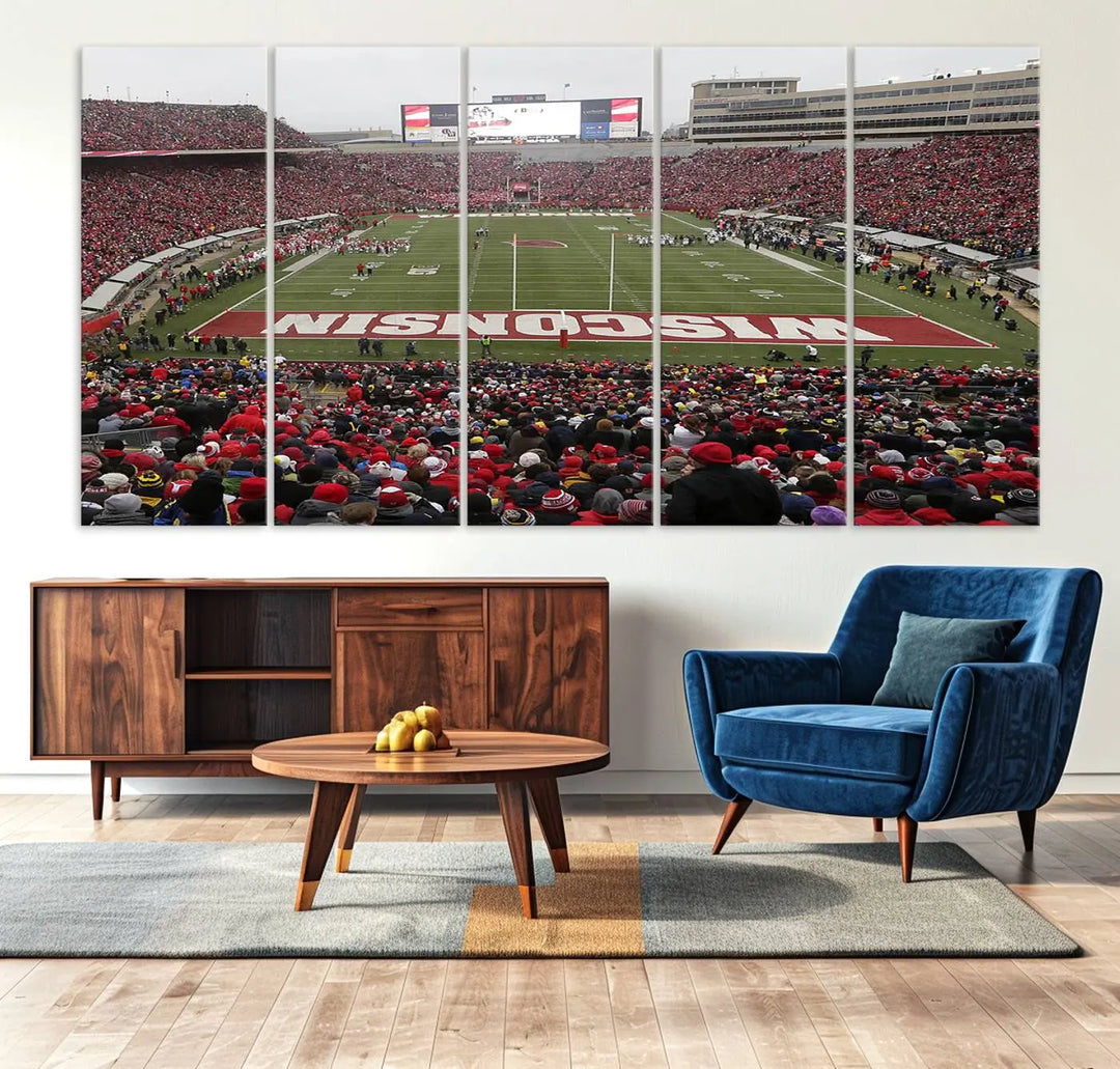 A living room exhibits the premium Wisconsin Badgers Football Team Print - Madison Camp Randall Stadium Wall Art Canvas Print, a triptych displaying an exciting game at Wisconsin. This canvas artwork infuses the space with vibrant energy.