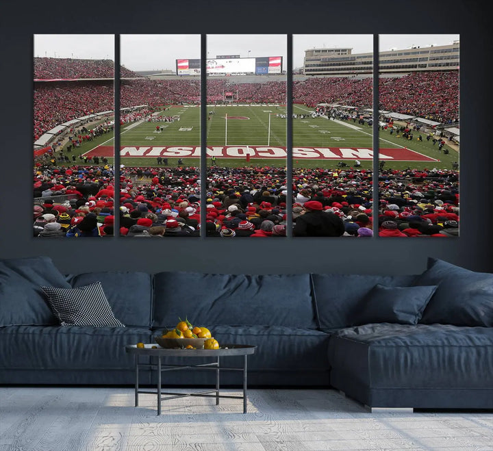 A living room exhibits the premium Wisconsin Badgers Football Team Print - Madison Camp Randall Stadium Wall Art Canvas Print, a triptych displaying an exciting game at Wisconsin. This canvas artwork infuses the space with vibrant energy.