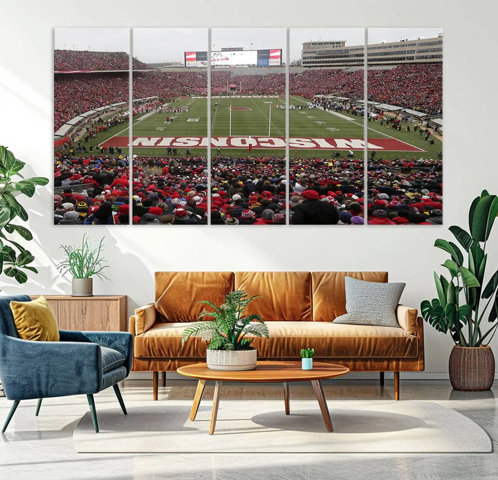 A living room exhibits the premium Wisconsin Badgers Football Team Print - Madison Camp Randall Stadium Wall Art Canvas Print, a triptych displaying an exciting game at Wisconsin. This canvas artwork infuses the space with vibrant energy.