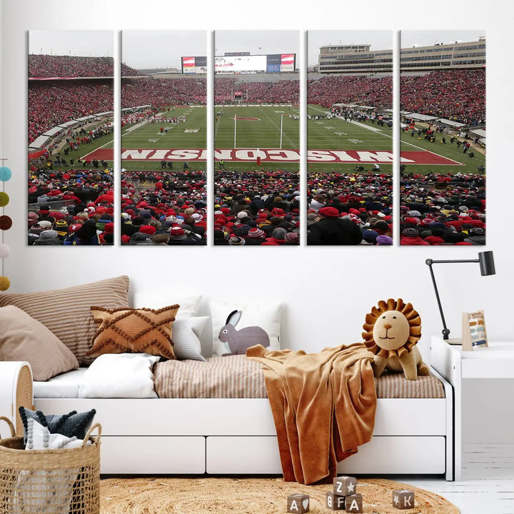 A living room exhibits the premium Wisconsin Badgers Football Team Print - Madison Camp Randall Stadium Wall Art Canvas Print, a triptych displaying an exciting game at Wisconsin. This canvas artwork infuses the space with vibrant energy.