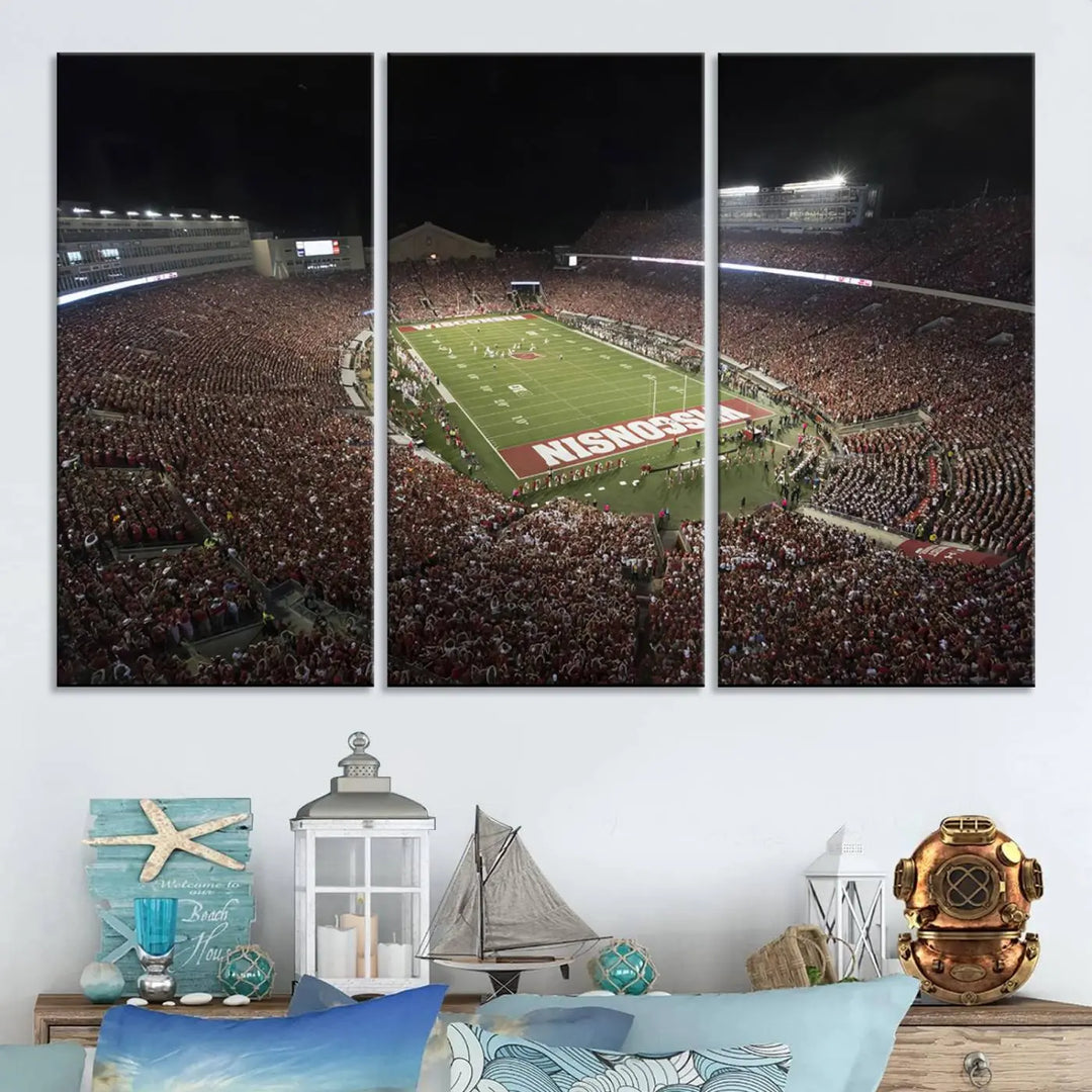 The Madison Camp Randall Stadium wall art canvas print showcases the Wisconsin Badgers football team, capturing a packed stadium at night. This three-panel piece is handmade in the USA.