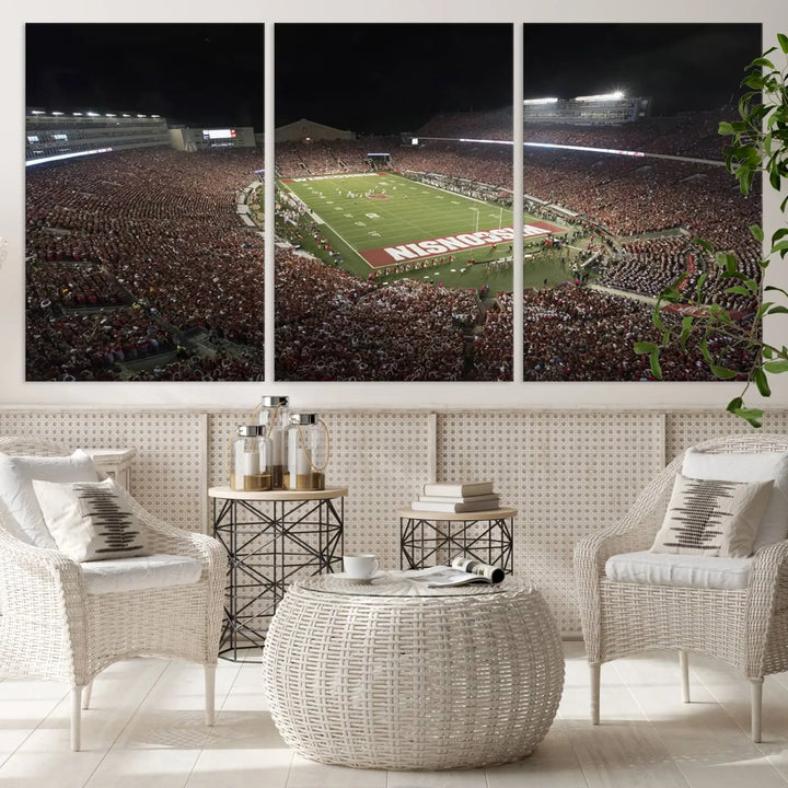 The Madison Camp Randall Stadium wall art canvas print showcases the Wisconsin Badgers football team, capturing a packed stadium at night. This three-panel piece is handmade in the USA.