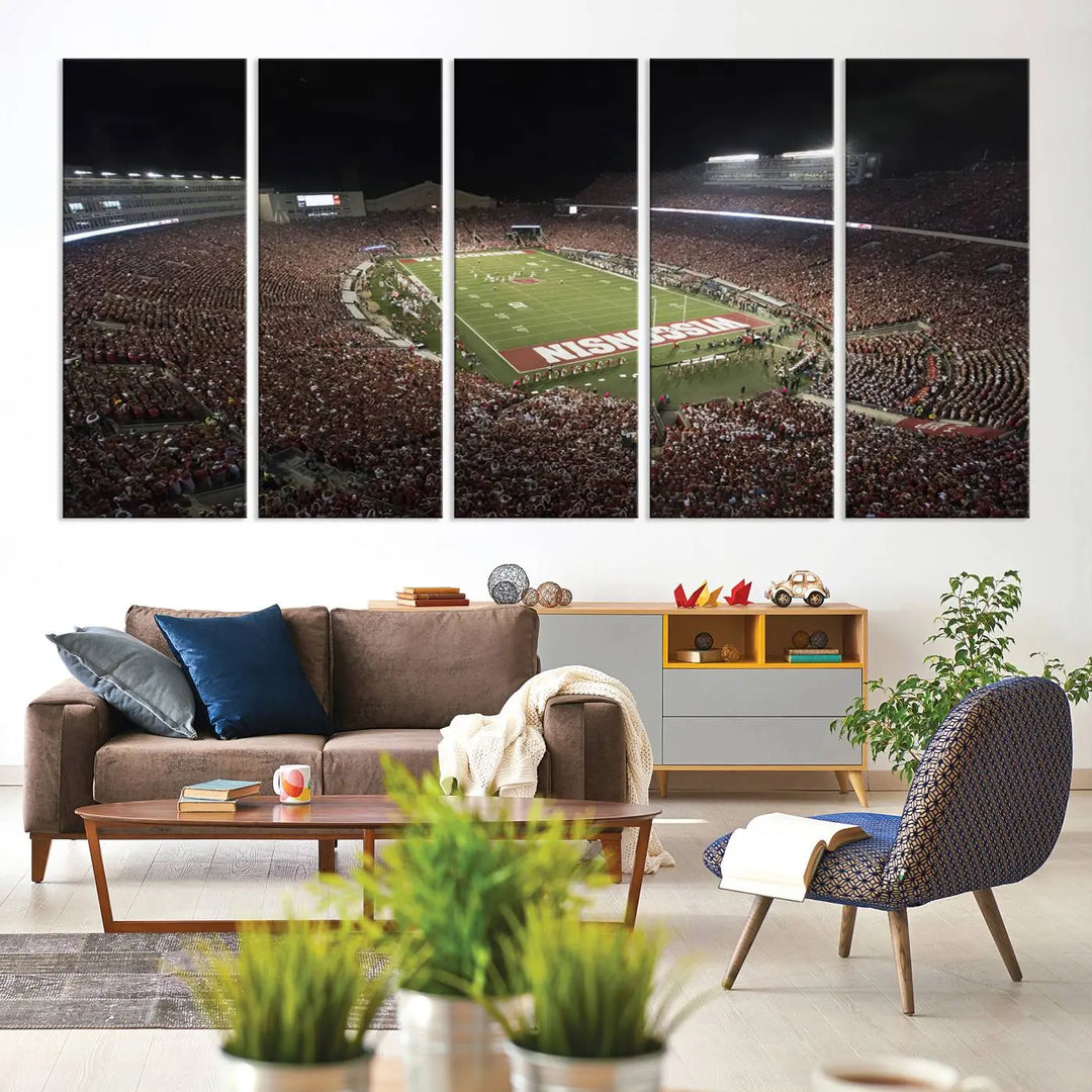 The Madison Camp Randall Stadium wall art canvas print showcases the Wisconsin Badgers football team, capturing a packed stadium at night. This three-panel piece is handmade in the USA.