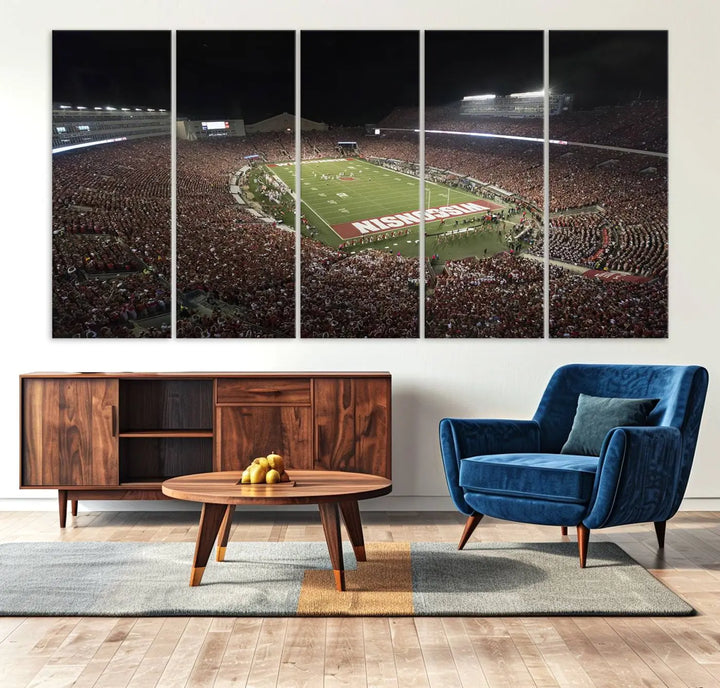 The Madison Camp Randall Stadium wall art canvas print showcases the Wisconsin Badgers football team, capturing a packed stadium at night. This three-panel piece is handmade in the USA.