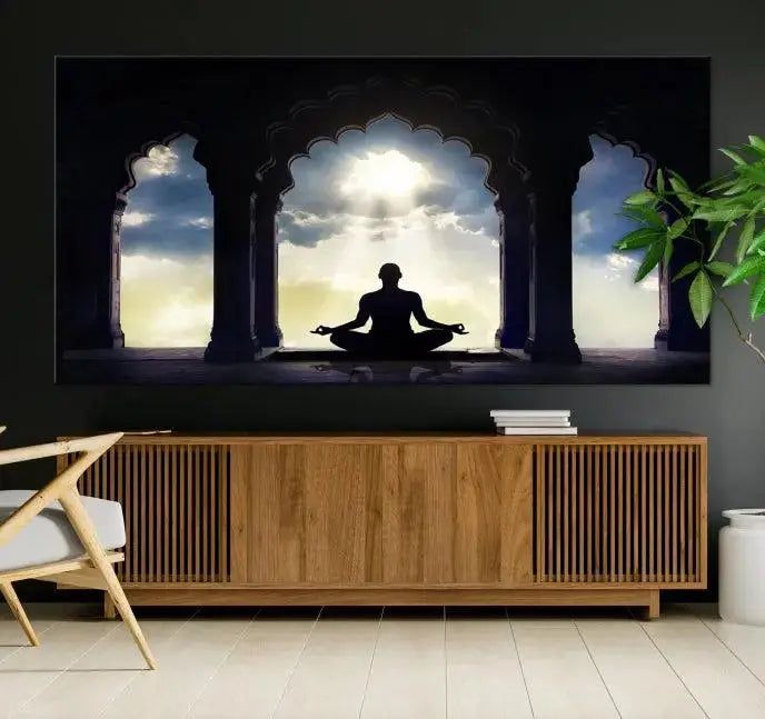 A triptych canvas print named "Women and Yoga Wall Art Canvas Print" beautifully captures a woman meditating in a temple against a backdrop of cloudy skies, showcasing graceful yoga poses. This serene artwork is displayed elegantly.