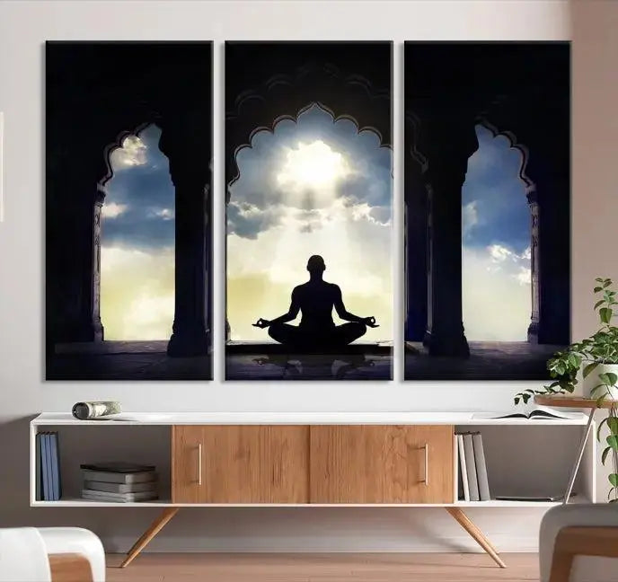 A triptych canvas print named "Women and Yoga Wall Art Canvas Print" beautifully captures a woman meditating in a temple against a backdrop of cloudy skies, showcasing graceful yoga poses. This serene artwork is displayed elegantly.