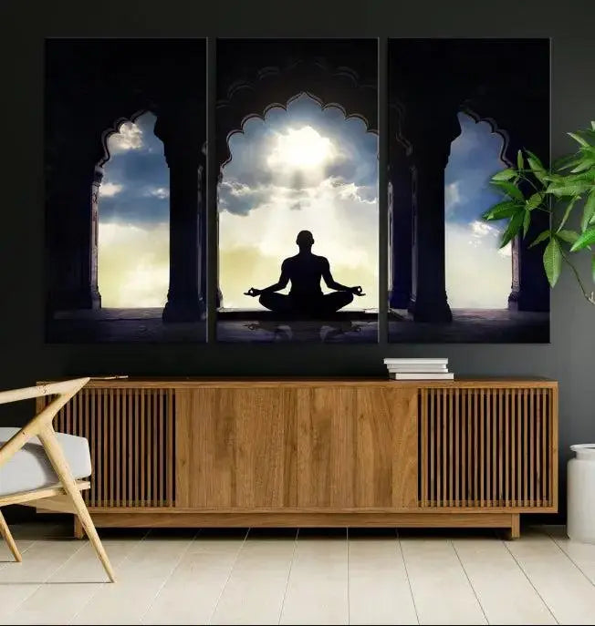 A triptych canvas print named "Women and Yoga Wall Art Canvas Print" beautifully captures a woman meditating in a temple against a backdrop of cloudy skies, showcasing graceful yoga poses. This serene artwork is displayed elegantly.