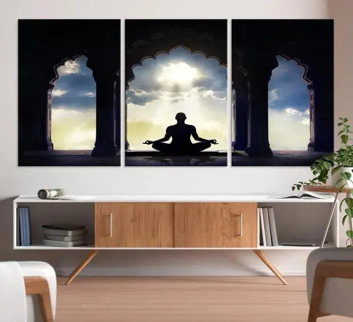 A triptych canvas print named "Women and Yoga Wall Art Canvas Print" beautifully captures a woman meditating in a temple against a backdrop of cloudy skies, showcasing graceful yoga poses. This serene artwork is displayed elegantly.