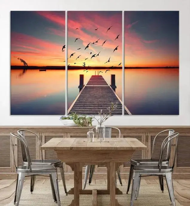 The Wood Bridge and Sunset Wall Art Canvas Print showcases a tranquil sunset scene featuring a wooden dock, soaring birds, and a vibrant sky. It comes ready to hang.