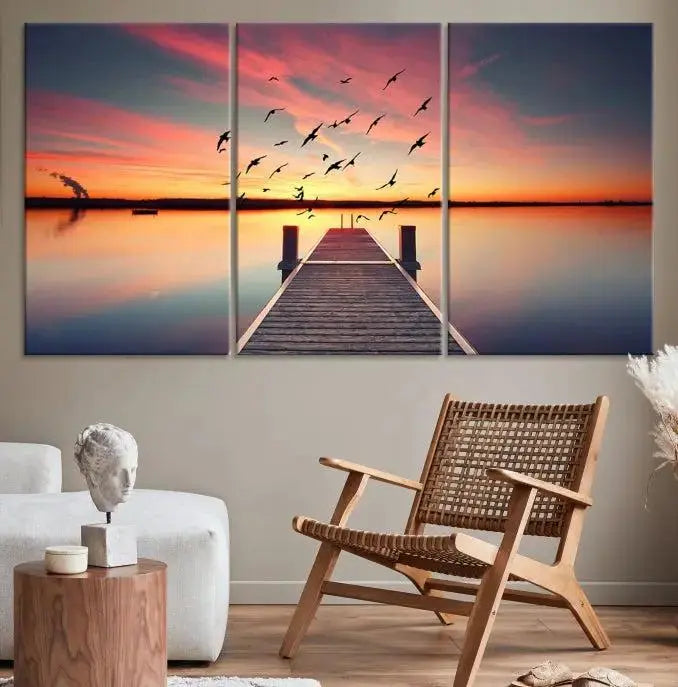 The Wood Bridge and Sunset Wall Art Canvas Print showcases a tranquil sunset scene featuring a wooden dock, soaring birds, and a vibrant sky. It comes ready to hang.