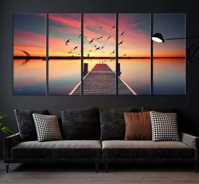 The Wood Bridge and Sunset Wall Art Canvas Print showcases a tranquil sunset scene featuring a wooden dock, soaring birds, and a vibrant sky. It comes ready to hang.