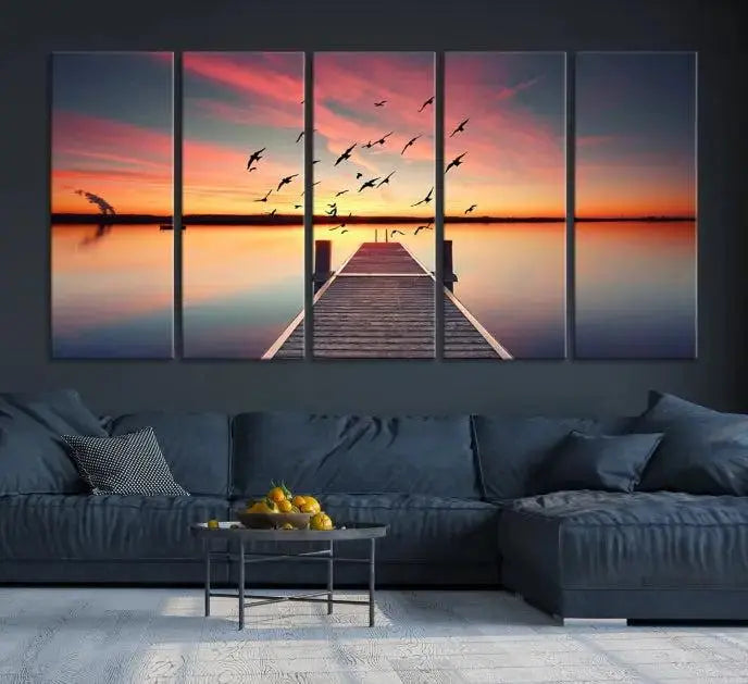 The Wood Bridge and Sunset Wall Art Canvas Print showcases a tranquil sunset scene featuring a wooden dock, soaring birds, and a vibrant sky. It comes ready to hang.