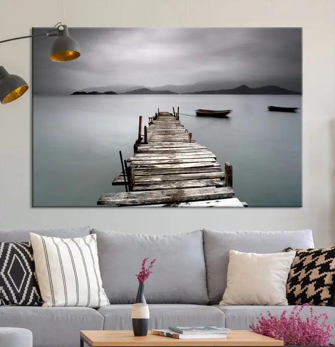 The Wood Pier Wall Art Canvas Print, a triptych featuring a wooden pier stretching into a tranquil, misty lake, is elegantly displayed in the room. This gallery-wrapped artwork is crafted from museum-quality polycotton and includes a UV-protective coating to ensure durability and vibrant colors for years to come.