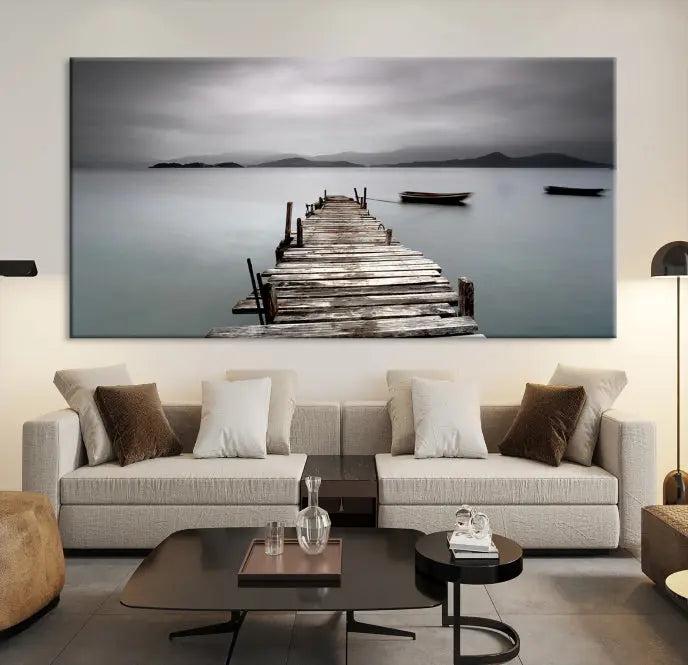 The Wood Pier Wall Art Canvas Print, a triptych featuring a wooden pier stretching into a tranquil, misty lake, is elegantly displayed in the room. This gallery-wrapped artwork is crafted from museum-quality polycotton and includes a UV-protective coating to ensure durability and vibrant colors for years to come.