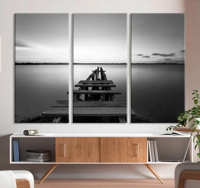 The "Wood Pier and Sea" wall art canvas print is a triptych featuring a wooden dock stretching into a serene lake, beautifully presented on gallery-wrapped museum-quality canvas.