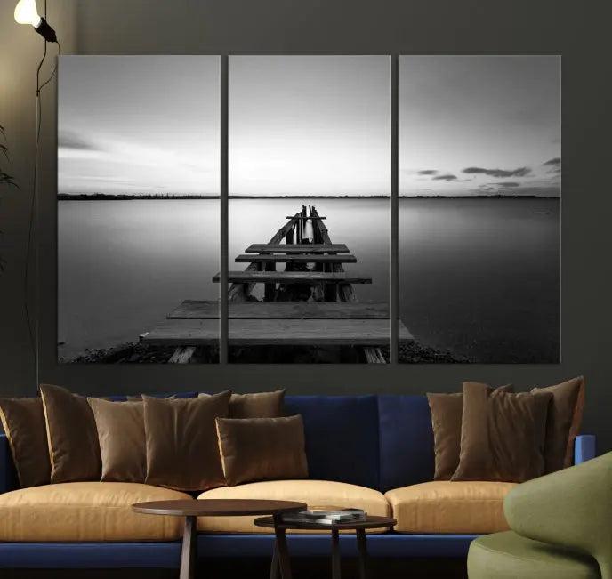 The "Wood Pier and Sea" wall art canvas print is a triptych featuring a wooden dock stretching into a serene lake, beautifully presented on gallery-wrapped museum-quality canvas.