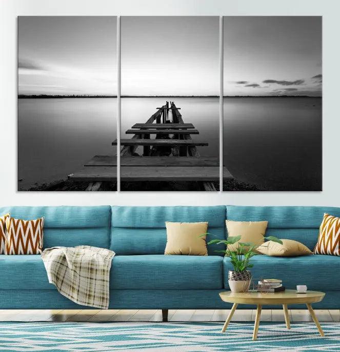 The "Wood Pier and Sea" wall art canvas print is a triptych featuring a wooden dock stretching into a serene lake, beautifully presented on gallery-wrapped museum-quality canvas.