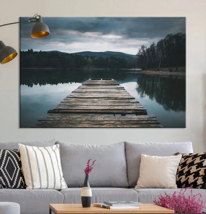 A serene triptych featuring the "Wooden Bridge Near Lake Wall Art Canvas Print" is showcased, depicting a tranquil lake with a wooden pier amidst trees and mountains on museum-quality canvas.