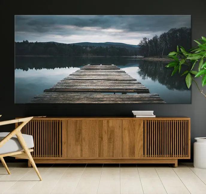 A serene triptych featuring the "Wooden Bridge Near Lake Wall Art Canvas Print" is showcased, depicting a tranquil lake with a wooden pier amidst trees and mountains on museum-quality canvas.