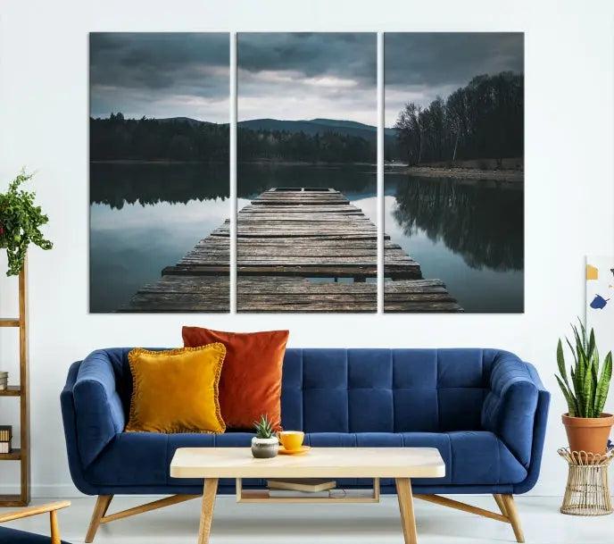 A serene triptych featuring the "Wooden Bridge Near Lake Wall Art Canvas Print" is showcased, depicting a tranquil lake with a wooden pier amidst trees and mountains on museum-quality canvas.