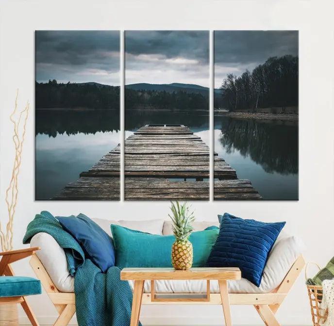 A serene triptych featuring the "Wooden Bridge Near Lake Wall Art Canvas Print" is showcased, depicting a tranquil lake with a wooden pier amidst trees and mountains on museum-quality canvas.