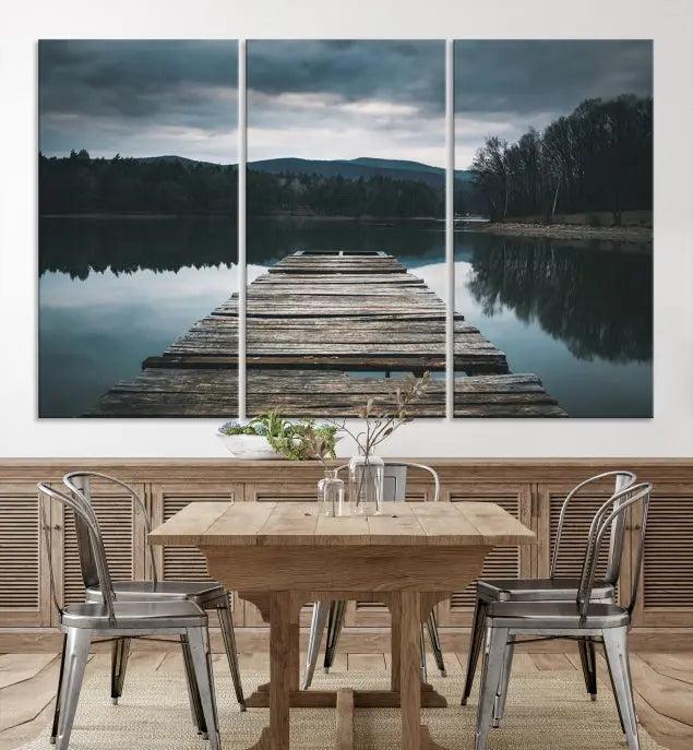 A serene triptych featuring the "Wooden Bridge Near Lake Wall Art Canvas Print" is showcased, depicting a tranquil lake with a wooden pier amidst trees and mountains on museum-quality canvas.