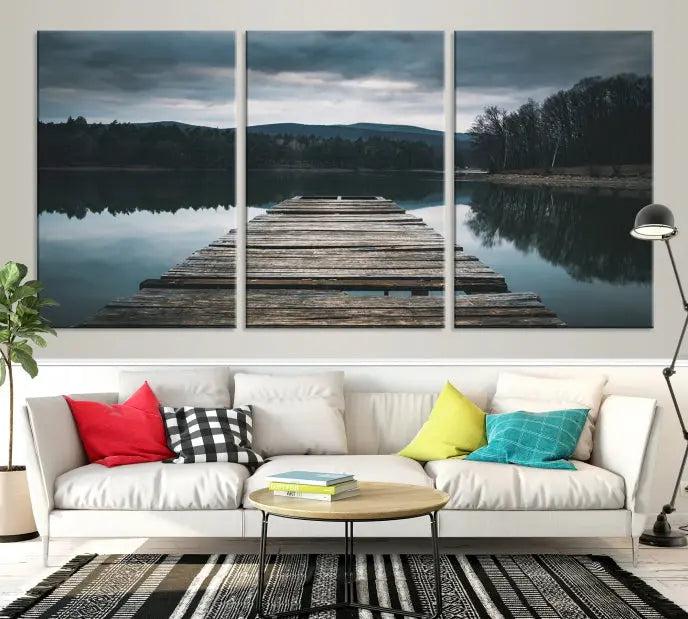 A serene triptych featuring the "Wooden Bridge Near Lake Wall Art Canvas Print" is showcased, depicting a tranquil lake with a wooden pier amidst trees and mountains on museum-quality canvas.