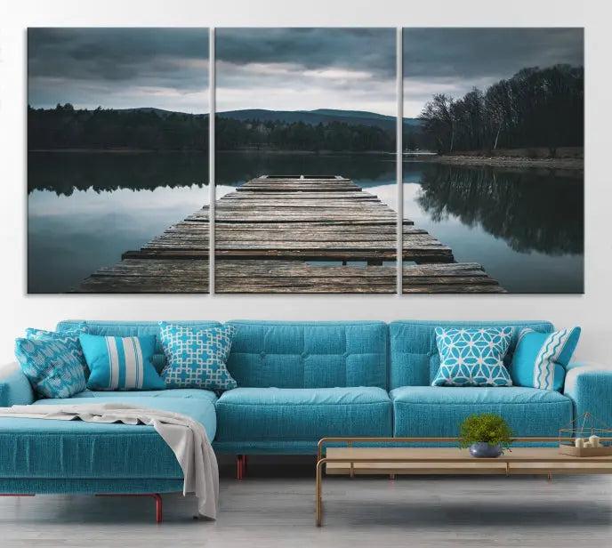 A serene triptych featuring the "Wooden Bridge Near Lake Wall Art Canvas Print" is showcased, depicting a tranquil lake with a wooden pier amidst trees and mountains on museum-quality canvas.