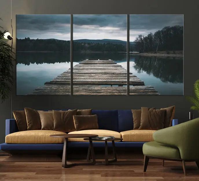 A serene triptych featuring the "Wooden Bridge Near Lake Wall Art Canvas Print" is showcased, depicting a tranquil lake with a wooden pier amidst trees and mountains on museum-quality canvas.