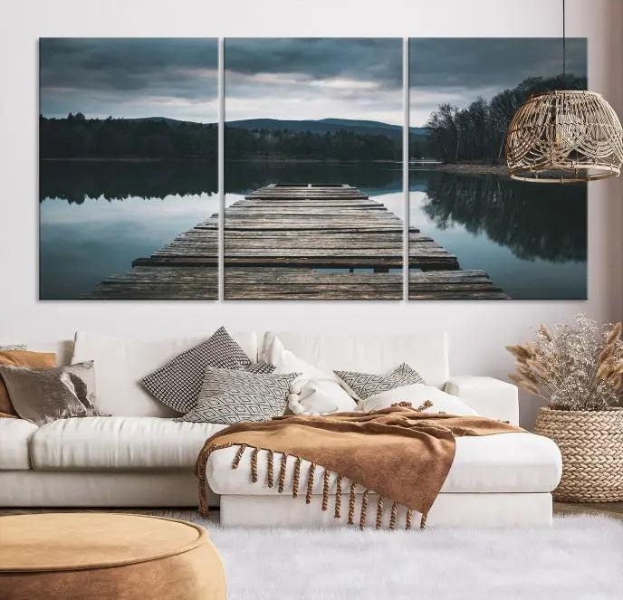 A serene triptych featuring the "Wooden Bridge Near Lake Wall Art Canvas Print" is showcased, depicting a tranquil lake with a wooden pier amidst trees and mountains on museum-quality canvas.