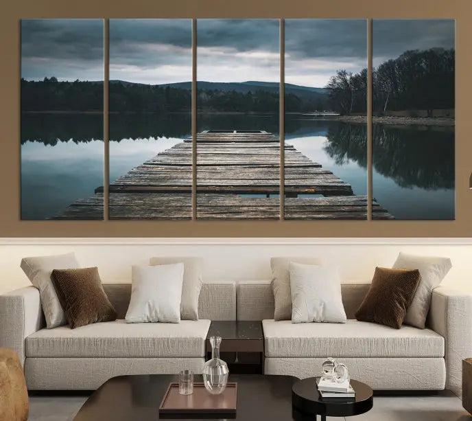 A serene triptych featuring the "Wooden Bridge Near Lake Wall Art Canvas Print" is showcased, depicting a tranquil lake with a wooden pier amidst trees and mountains on museum-quality canvas.