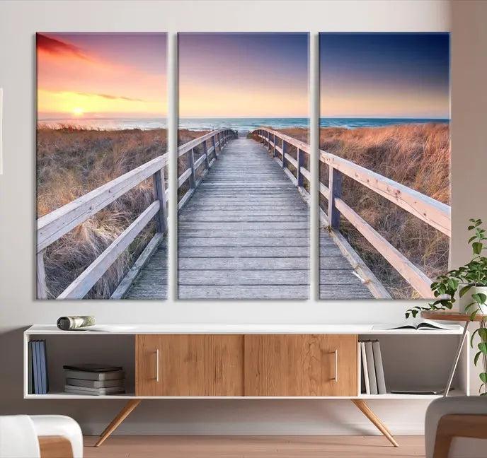 **Title:** Wooden Path at Baltic Sea Wall Art Canvas Print

**Description:** A triptych depicting a wooden boardwalk leading to a beach at sunset. This museum-quality canvas is ready to hang, offering an effortless enhancement to your decor.