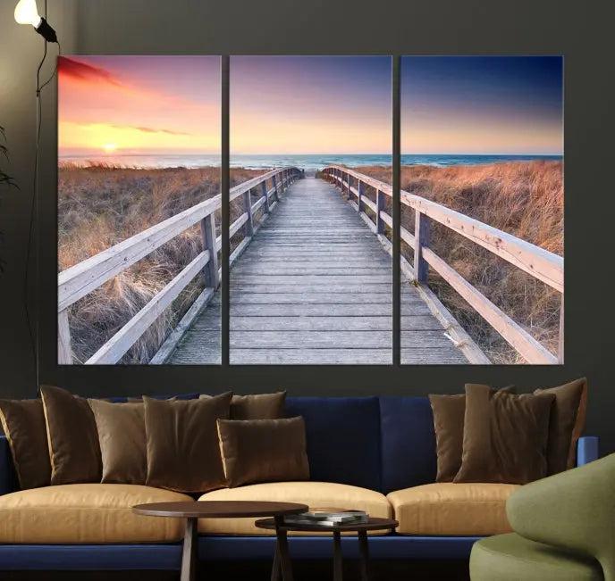 **Title:** Wooden Path at Baltic Sea Wall Art Canvas Print

**Description:** A triptych depicting a wooden boardwalk leading to a beach at sunset. This museum-quality canvas is ready to hang, offering an effortless enhancement to your decor.