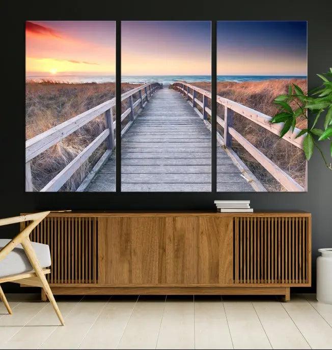 **Title:** Wooden Path at Baltic Sea Wall Art Canvas Print

**Description:** A triptych depicting a wooden boardwalk leading to a beach at sunset. This museum-quality canvas is ready to hang, offering an effortless enhancement to your decor.